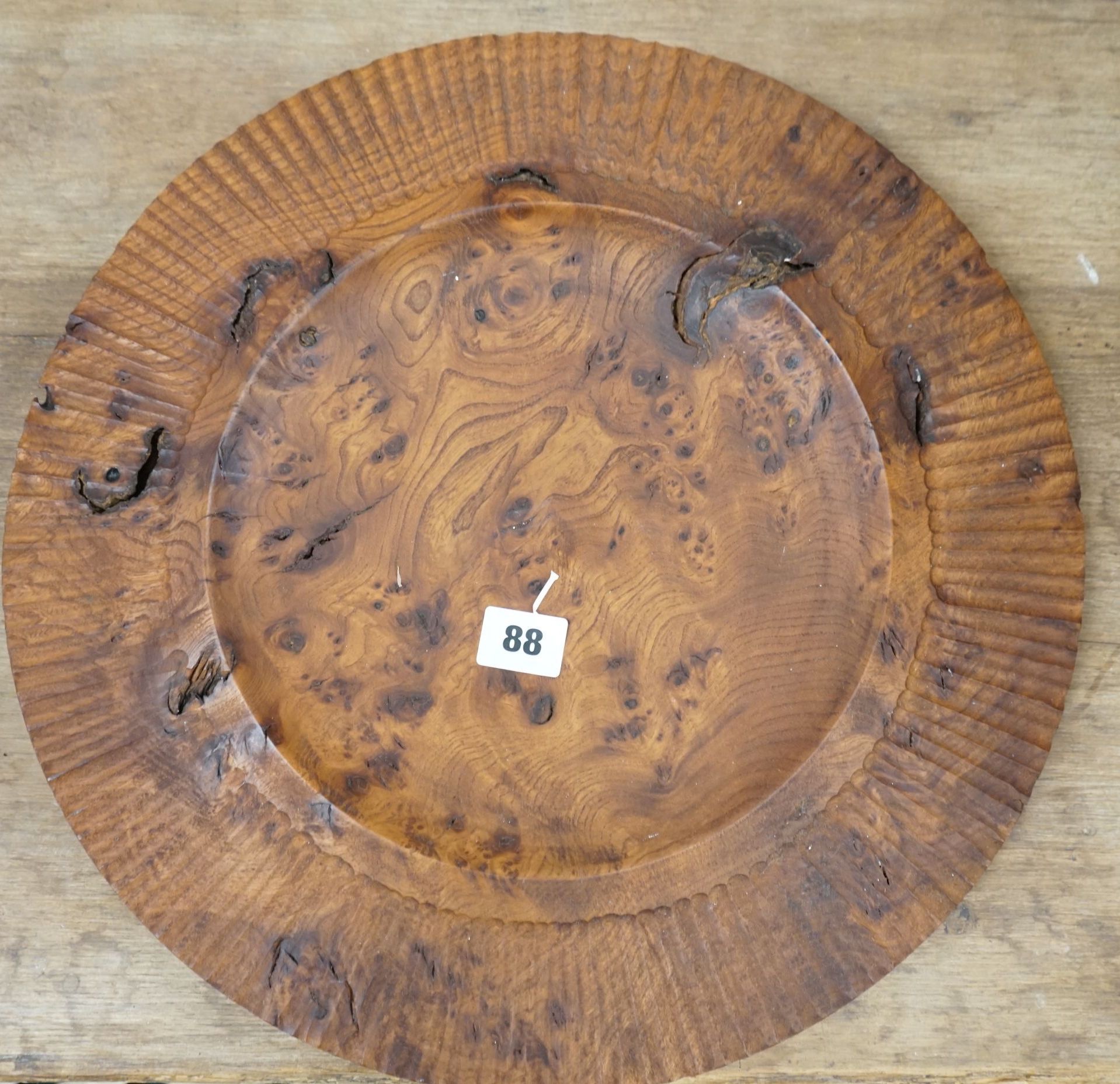 An Indian circular chip carved burr wood dish, diameter 39cm